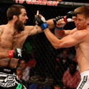 Matt Brown, left, lands a punch against Mike Pyle in their August 2013 fight. (Getty Images)