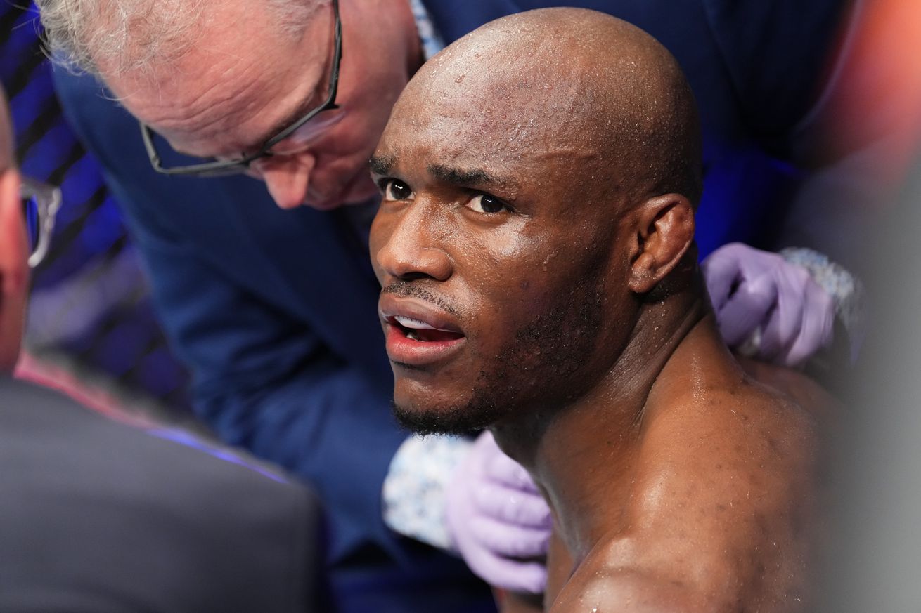 Kamaru Usman gets propped up after being knocked out by Leon Edwards at UFC 278.