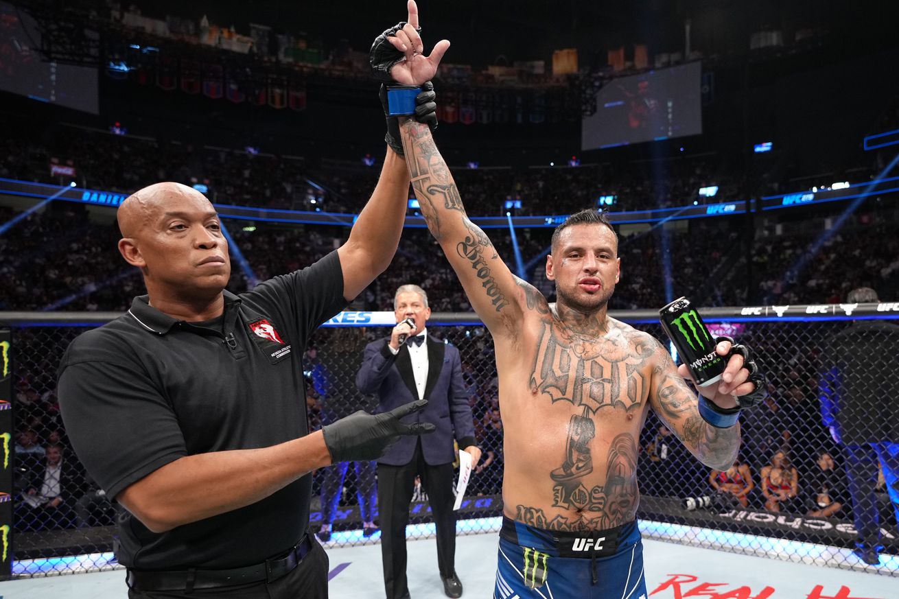 Daniel Rodriguez gets his hand raised after taking a split decision over Li Jingliang.