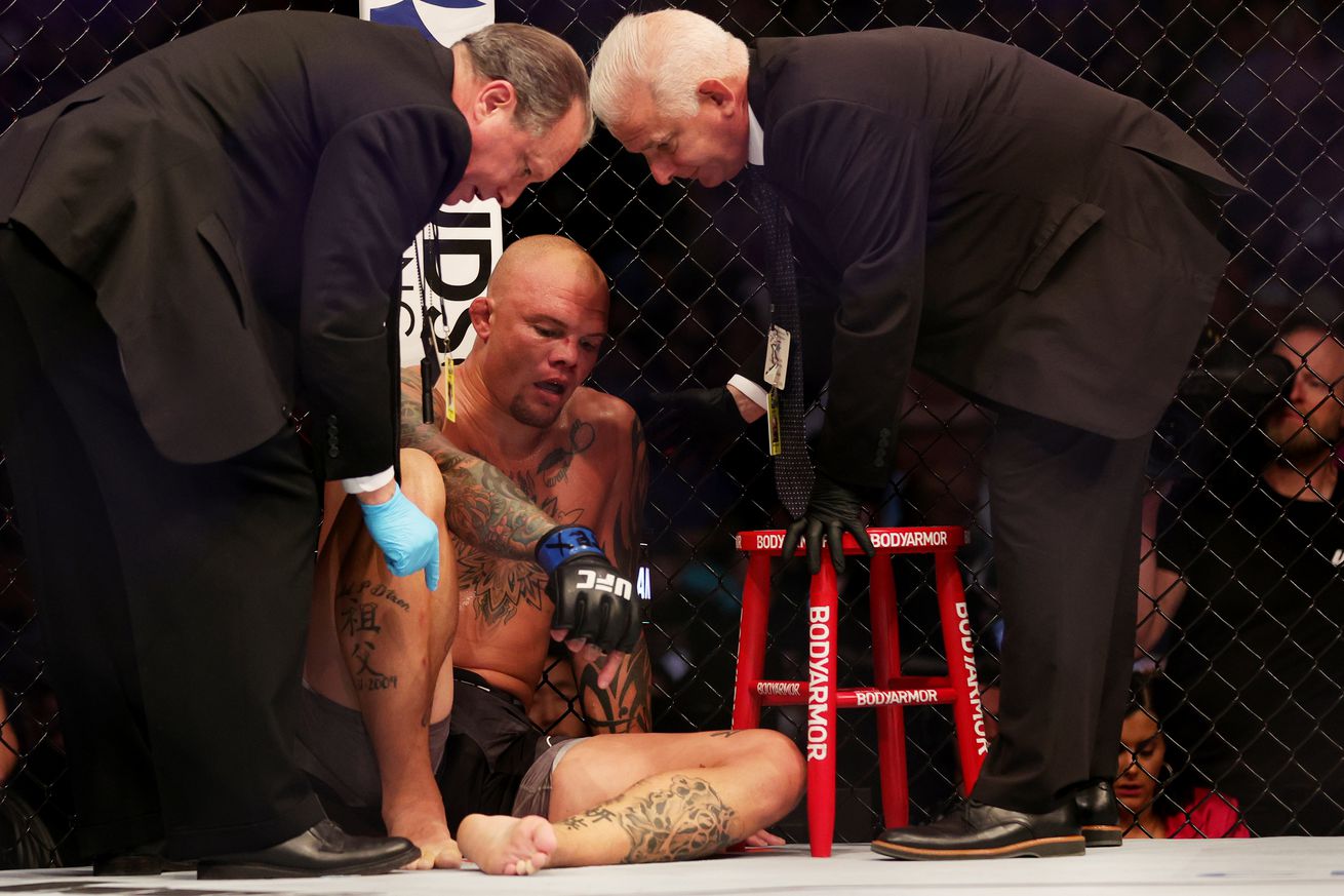 Anthony Smith gets attended to by cageside doctors after his UFC 277 ankle injury. 