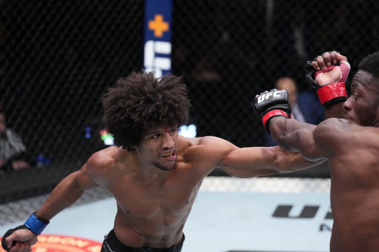 Alex Caceres lands a left hand against Sodiq Yusuff at UFC Vegas 50.