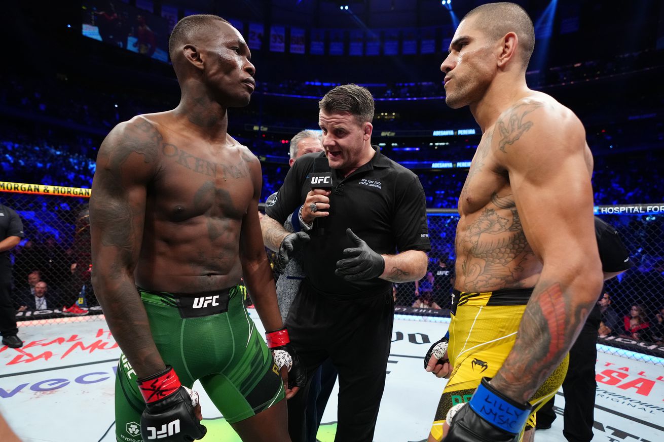Referee Marc Goddard giving instructions to Israel Adesanya and Alex Pereira at UFC 281. 