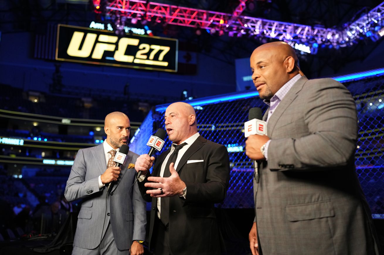 Jon Anik, Joe Rogan and Daniel Cormier doing commentary at UFC 277. 