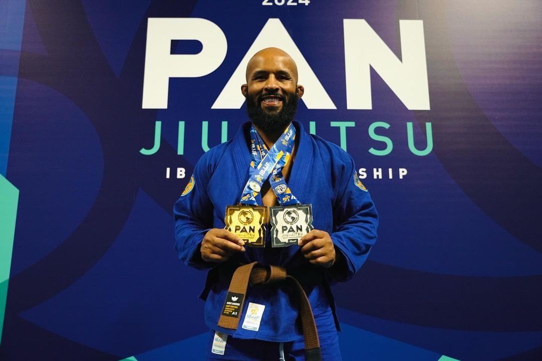 Demetrious Johnson holding his medals in Jiu-JiuJitsu